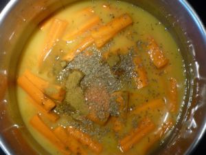 In a pan, add Orange Juice to cover the Carrots, Cumin Powder and Seeds, Sugar and Salt